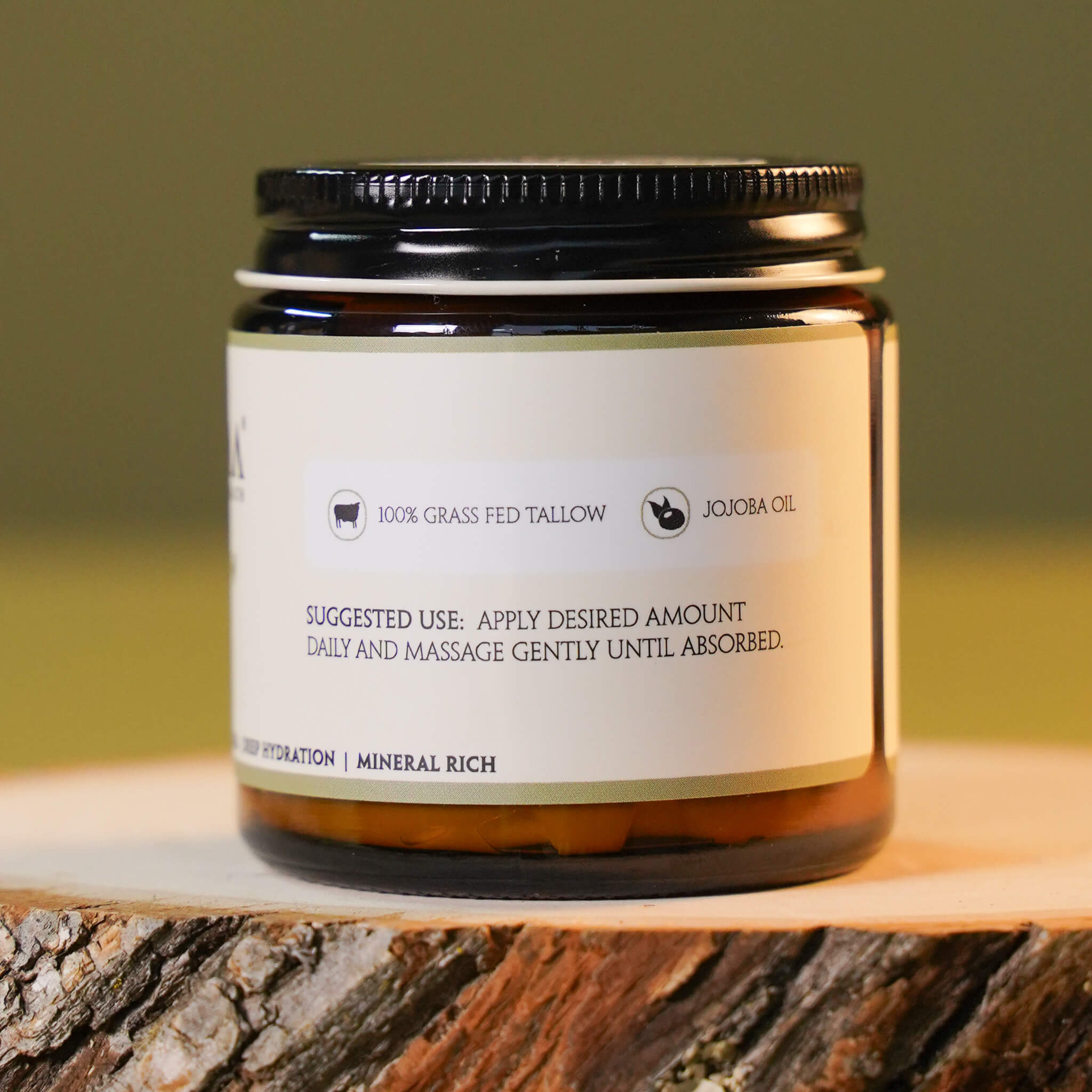 Jar of skincare product on a wooden surface with a blurred green background