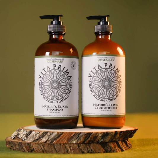 Two Vita Prima shampoo and conditioner bottles on a wooden platform with a green background