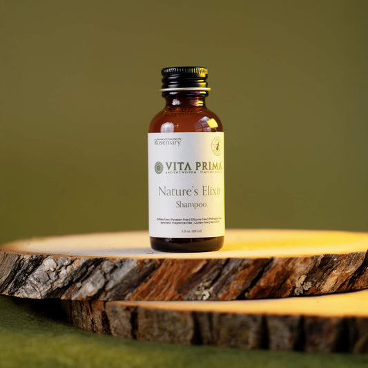 Vita Prima Nature's Elixir Shampoo bottle on a wooden surface with a green background